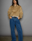 Vegan suede bomber jacket. Collar neckline. Front zipper closure. Elastic hems. Front pockets with snap button closures. Fully lined. tan suede bomber