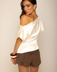 Satin asymmetrical off the shoulder top
Shoulder button closure
Front drape detail
Relaxed fit
Can be worn multiple ways
Side zipper closure
ivory satin short sleeve top