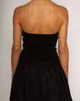 Strapless dress. Knit bodice. Woven skirt. Elastic neckline. Inner rubber grip lining. Side hook and eye and zipper closures. Unlined. Black mini dress. fall dress. holiday dress. friendsgiving dress. thanksgiving dress. summer dress. little black dress