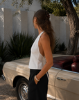 white Relaxed tailored fit halter top
Deep plunging halter neckline
Clean front paneling with center slit opening
Open-back design
Straight hip-length hem
Self-tie back closure with halter neck fastening
Unlined