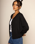 Fuzzy knit cardigan
Crewneck
Front button down closures
Long sleeves
Unlined
black cardigan
black basic cardigan
