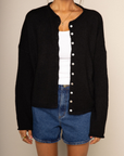 Fuzzy knit cardigan
Crewneck
Front button down closures
Long sleeves
Unlined
black cardigan
black basic cardigan