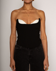 Color blocked woven bustier. Strapless neckline with inner rubber grip lining. Boning in bodice. Back hook and eye and zipper closures. Fully lined. black corset. going out top