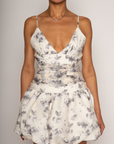 Floral printed woven dress. Adjustable straps. Ruched bodice. Bubble hem with elastic opening. Back hook and eye and zipper closures. Fully lined. bridal dress. bridal. bride. white mini bubble dress.