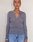grey Ribbed knit top
Henley neckline with button closure
Long sleeves
Unlined