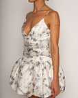 Floral printed woven dress. Adjustable straps. Ruched bodice. Bubble hem with elastic opening. Back hook and eye and zipper closures. Fully lined. bridal dress. bridal. bride. white mini bubble dress.