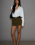 Animal printed denim skirt. Button and zipper fly. Five pocket construction. Frayed hem. Unlined. leopard mini skirt. going out mini skirt.