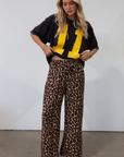 Animal printed woven pants. Elastic waistband with drawstring closure. Unlined.