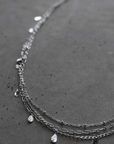 Three separate thin chain belly chains. Small bead and teardrop embellishments. Adjustable lobster clasp closures.
layered silver belly chain