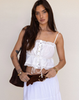 white Button down tank top
Lace trim
Adjustable front tie
Sleeveless
Straight neckline
Adjustable straps
summer tank top
country side tank top