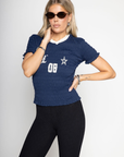Graphic printed elastic smocked crop top. V-neckline. Short sleeves. Contrast detailing. navy tee. lioness scrunched graphic tee