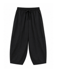 black Windbreaker material track pant
Mid rise
Ankle length
4 pocket construction
Adjustable elastic drawstring