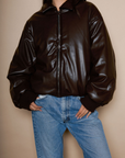 Faux leather jacket. Collar neckline. Long sleeves with elastic openings. Front zipper closures. Side pockets with snap button closure. Elastic hem. Fully lined. brown puffer jacket. brown puffer bomber jacket. fall jacket. bomber jacket. going out jacket