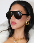 Sleek, modern aviator silhouette sunglasses
Polished black frame and warm brown lenses.
Designed for a lightweight, comfortable fit with full UV protection.
A clean everyday shape that works with any look — hot without trying