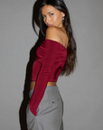Knit crop top. Strapless elastic folded neckline. Front and back ruching. Long sleeves. Unlined. red off the shoulder long sleeve top. burgundy off the shoulder long sleeve top. holiday outfit. holiday look. christmas top. christmas outfit