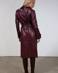 Faux leather trench coat. Collar neckline. Double breasted. Front button closures. Belted waist. Side pockets. Fully lined. burgundy faux leather trench coat. fall outfit. fall trench coat