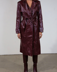 Faux leather trench coat. Collar neckline. Double breasted. Front button closures. Belted waist. Side pockets. Fully lined. burgundy faux leather trench coat. fall outfit. fall trench coat