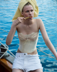 cream Sleek satin bustier with lace detailing
Fully boned bodice
Adjustable lace-up back
Skinny tie bow
Rosette adornments
Lined at cups
Adjustable shoulder straps
Polyester/Elastane
cream ligneire bustier top