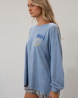 blue Graphic printed acid wash knit top. Crewneck. Long sleeves. Unlined.