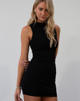 Sleeveless knit dress. Mock neck. Ruched sides. Fully lined. black mini dress. black mock neck mini dress. fall dress. fall outfit