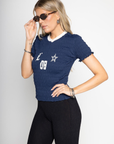 Graphic printed elastic smocked crop top. V-neckline. Short sleeves. Contrast detailing. navy tee. lioness scrunched graphic tee