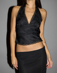 black Satin crop tank. Lace trim. Halter tie neckline. Side hook and eye and zipper closures. Elastic back. Fully lined. black halter crop tank. going out top. holiday look. holiday outfit