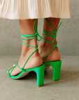 Newly designed in an electrifying neon shade. Inspired by a classic feminine silhouette, the Bellini sandals represent the ultimate combination of glamour and comfort. Crafted in soft leather, this lace-up style wraps around the ankle in a barely there delicate sandal that is perfect for any special occasion. green strappy heel