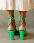 Newly designed in an electrifying neon shade. Inspired by a classic feminine silhouette, the Bellini sandals represent the ultimate combination of glamour and comfort. Crafted in soft leather, this lace-up style wraps around the ankle in a barely there delicate sandal that is perfect for any special occasion. green strappy heel