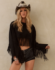 black Faux suede long sleeve top
Fringe hem
Adjustable sleeve tie
Unlined
