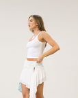 Knit skirt. Elastic waist. Ruched waist. Asymmetric hem. Unlined. White skirt