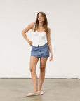 Denim skirt. Hook and eye and zipper fly. Five pocket construction. Unlined.Mini skirt. Denim mini skirt