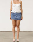 Denim skirt. Hook and eye and zipper fly. Five pocket construction. Unlined.Mini skirt. Denim mini skirt