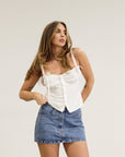 Denim skirt. Hook and eye and zipper fly. Five pocket construction. Unlined.Mini skirt. Denim mini skirt
