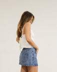 Denim skirt. Hook and eye and zipper fly. Five pocket construction. Unlined.Mini skirt. Denim mini skirt