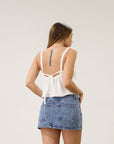 Denim skirt. Hook and eye and zipper fly. Five pocket construction. Unlined.Mini skirt. Denim mini skirt