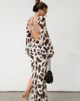 Printed chiffon maxi dress. Long bell sleeves. Adjustable crisscross back straps. Side slit. Fully lined. Dinner dress. Classy dinner dress. Fancy dinner dress. Nice dinner dress. Dressed up vacation outfits. Dress to wear on vacation. Nice dress to wear on vacation. Open back dress