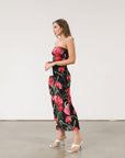 Floral printed knit mesh dress. Elastic strapless neckline. Inner rubber grip lining. Back slit. Black dress with large red floral.