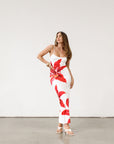 Floral printed knit maxi dress. Adjustable straps. Back slit. Fully lined. White maxi dress with crimson lily print.