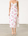 Floral printed satin maxi dress. Adjustable tie straps. Front slot. Adjustable back tie closures. Unlined for love and lemons dress. floral slip dress with lace detail and slit.
