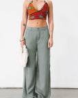 Woven wide leg pants. Low slung palazzo pant. No stretch. Button and zipper fly. Side pockets. Faux back pockets. Unlined. Green pants. Green trousers. Olive trousers. Business casual pants
