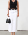 Denim midi skirt. Button and zipper fly. Five pocket construction. Front slit. Raw hem. Unlined. Relaxed fit that's designed to sit at the hips. No stretch. white denim maxi skirt. denim skirt with slit.