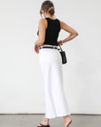 Denim midi skirt. Button and zipper fly. Five pocket construction. Front slit. Raw hem. Unlined. Relaxed fit that's designed to sit at the hips. No stretch. white denim maxi skirt. denim skirt with slit.