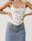 Floral printed woven bustier top. Fixed straps. Back hook and eye and zipper closures. Fully lined. White with blue floral top. Corset top.