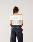 Knit Tube top. Strapless neckline. Front wire. Ruched bodice. Back cut out. Partially lined