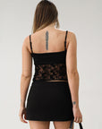 Knit and lace crop tank top. Adjustable straps. Partially lined.