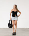 Knit Tube top. Elastic strapless neckline. Inner rubber grip lining. Ruched sides. Front slit. Unlined. Black tube top. 