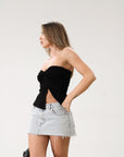 Knit Tube top. Elastic strapless neckline. Inner rubber grip lining. Ruched sides. Front slit. Unlined. Black tube top. 