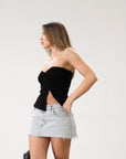Knit Tube top. Elastic strapless neckline. Inner rubber grip lining. Ruched sides. Front slit. Unlined. Black tube top.