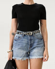 High-waisted faded and distressed denim shorts. Button and zipper fly closures. Five pocket construction. Frayed hem. True to size. Size up for a more relaxed look.