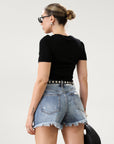 High-waisted faded and distressed denim shorts. Button and zipper fly closures. Five pocket construction. Frayed hem. True to size. Size up for a more relaxed look.